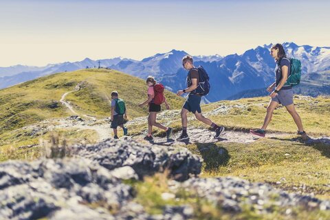 Eine Familie wandert vor einer traumhaften Bergkulisse