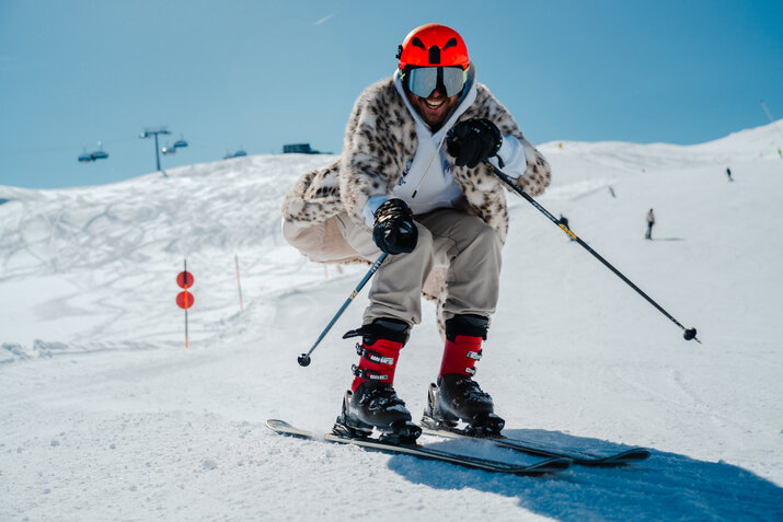 ein Mann beim Skifahren mit Fellmantel